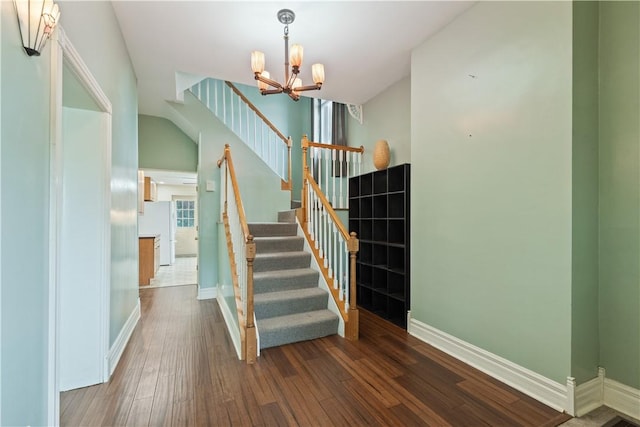 2101 Lonsdale St, Reserve, PA 15212 - staircase with wood finished floors, a chandelier, and baseboards