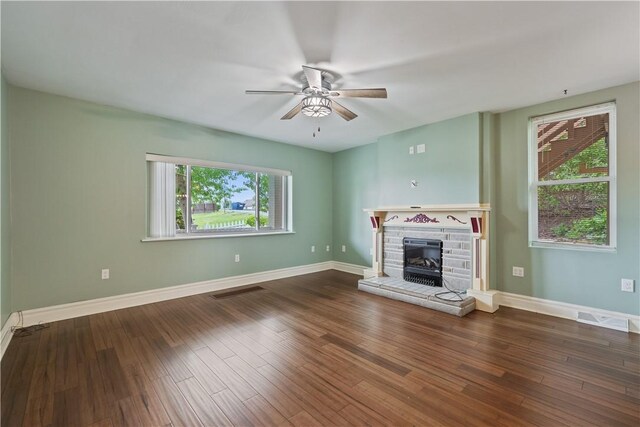 2101 Lonsdale St, Reserve, PA 15212 - unfurnished living room featuring a ceiling fan, plenty of natural light, a stone fireplace, and wood finished floors