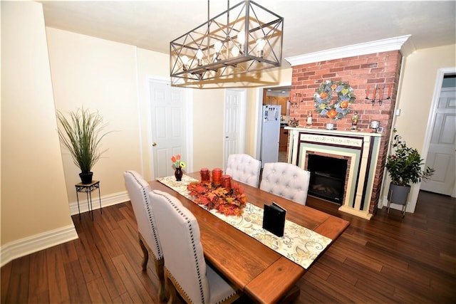 dining area with dark wood-style floors, a fireplace, baseboards, and a notable chandelier