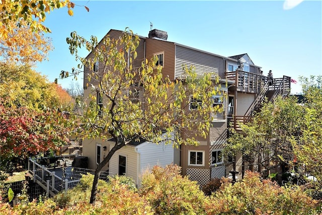 view of side of home featuring stairs
