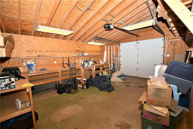 garage with a workshop area and a garage door opener