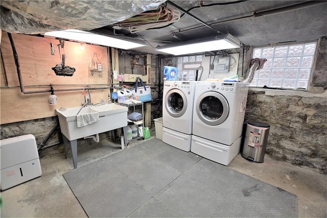 laundry area with a sink, laundry area, and washer and dryer