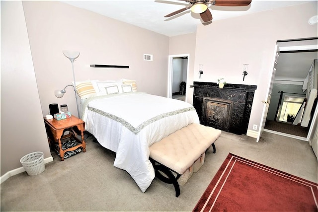 bedroom with light carpet, baseboards, visible vents, a ceiling fan, and a fireplace