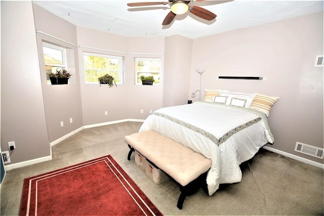bedroom with a ceiling fan, carpet flooring, visible vents, and baseboards