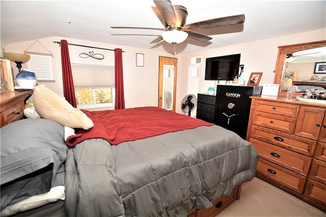 bedroom featuring a ceiling fan, visible vents, and light colored carpet