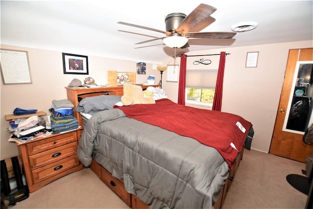 bedroom featuring visible vents, a ceiling fan, and light colored carpet