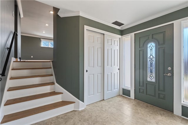 foyer with stairway, visible vents, and crown molding