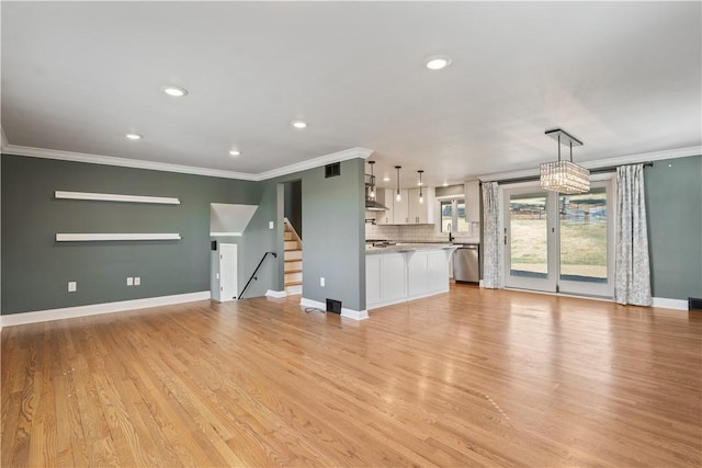 unfurnished living room with baseboards, stairway, crown molding, light wood-style floors, and recessed lighting