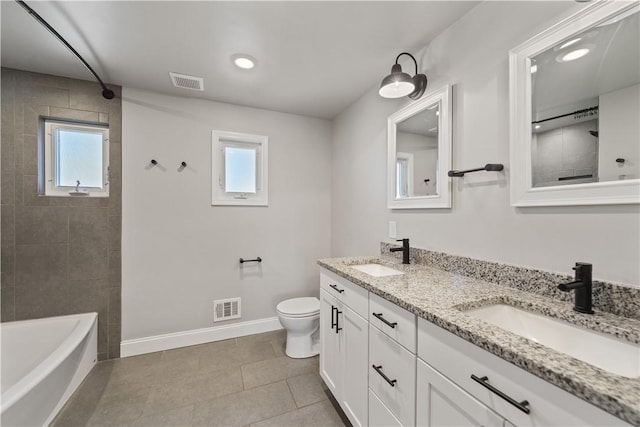 bathroom featuring toilet, visible vents, and a sink