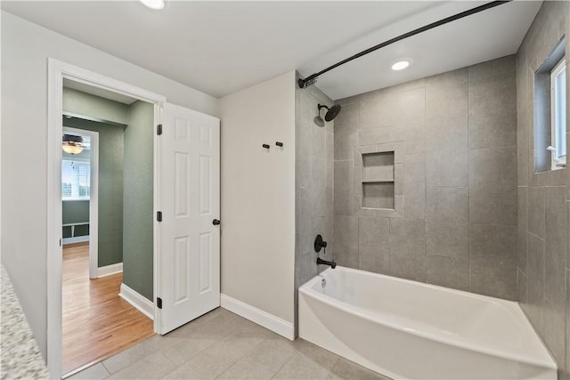 bathroom with  shower combination, tile patterned flooring, and baseboards