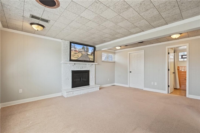 unfurnished living room with carpet floors, ornamental molding, a fireplace, and visible vents