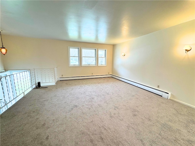 unfurnished room with a baseboard heating unit and carpet flooring