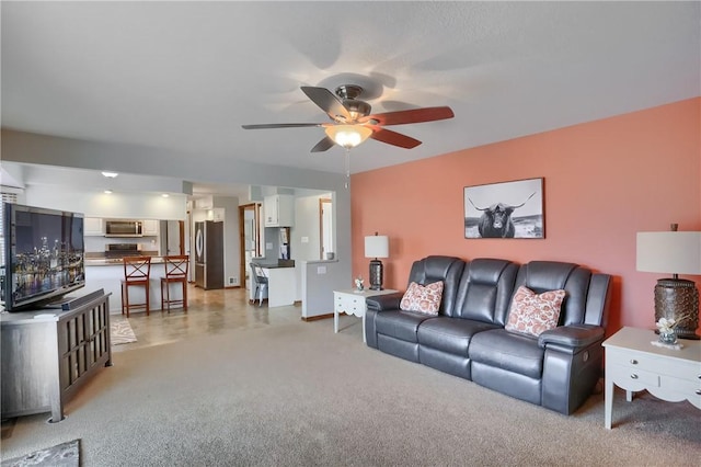 living room featuring light colored carpet and ceiling fan