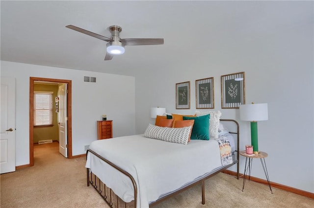 bedroom featuring light carpet, ceiling fan, visible vents, and baseboards