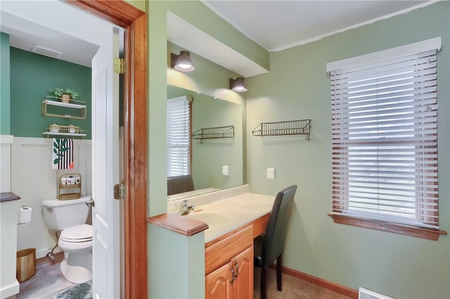 bathroom with toilet, baseboards, visible vents, and vanity