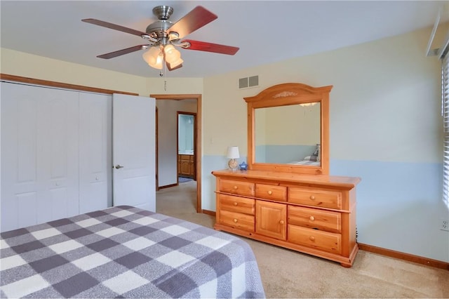 bedroom with light carpet, a ceiling fan, visible vents, baseboards, and a closet