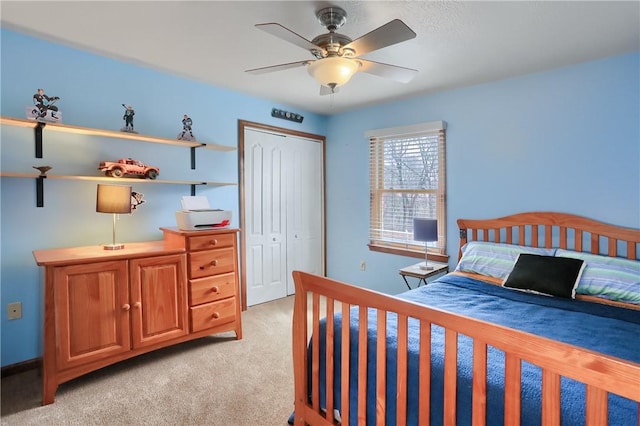 bedroom with a closet, light colored carpet, and ceiling fan