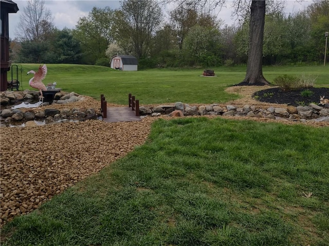 view of yard featuring an outbuilding and a shed