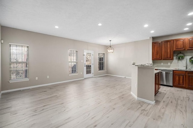 kitchen with baseboards, dishwasher, light countertops, light wood-style floors, and recessed lighting