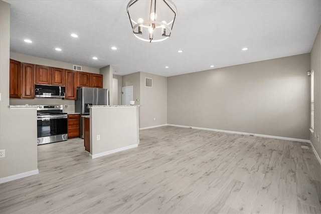 kitchen with visible vents, open floor plan, light countertops, appliances with stainless steel finishes, and light wood-type flooring