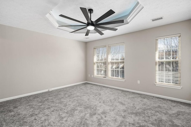 empty room with baseboards, visible vents, and a textured ceiling