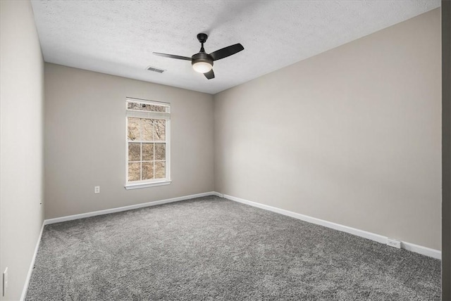 empty room with baseboards, visible vents, a ceiling fan, carpet, and a textured ceiling