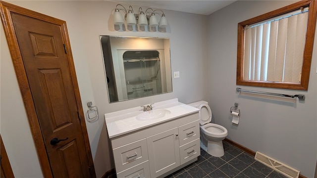 bathroom with baseboards, visible vents, toilet, walk in shower, and vanity