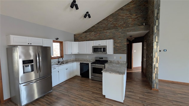 kitchen with stainless steel appliances, dark wood-type flooring, a sink, and white cabinetry