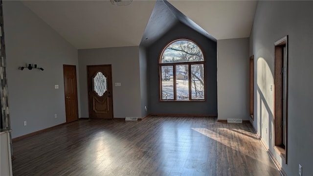 entryway featuring visible vents, baseboards, vaulted ceiling, and wood finished floors