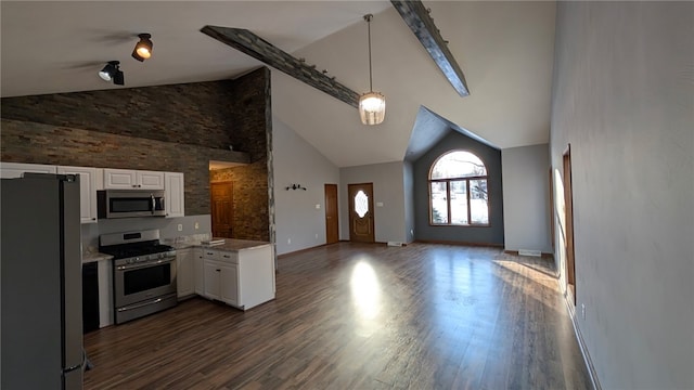 kitchen with high vaulted ceiling, white cabinetry, open floor plan, appliances with stainless steel finishes, and dark wood-style floors