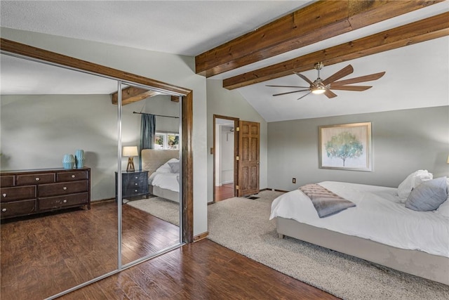 bedroom featuring vaulted ceiling with beams, a closet, ceiling fan, wood finished floors, and baseboards