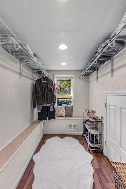 spacious closet with visible vents and wood finished floors