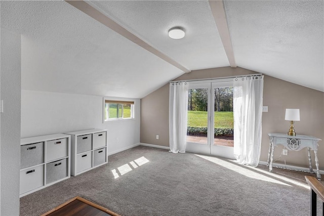 additional living space featuring lofted ceiling with beams, baseboards, a textured ceiling, and carpet flooring