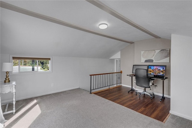 carpeted office space with vaulted ceiling with beams, baseboards, and wood finished floors