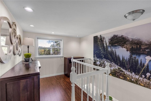 bedroom featuring recessed lighting, a water view, baseboards, and wood finished floors