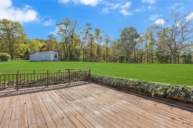 wooden terrace featuring a yard and an outdoor structure