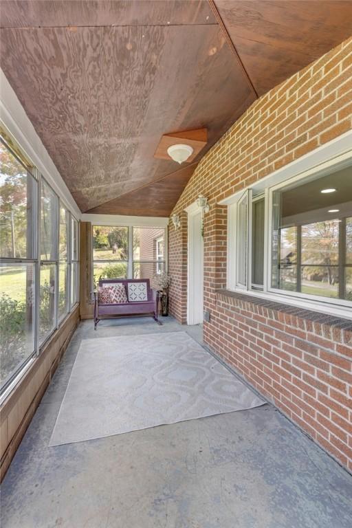 unfurnished sunroom with vaulted ceiling