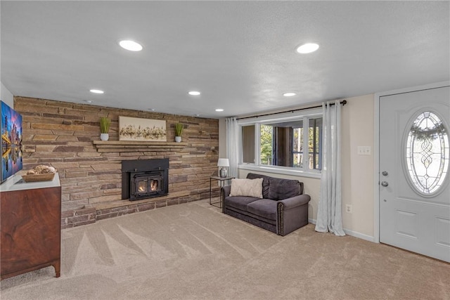 carpeted living room with recessed lighting, a wood stove, and baseboards