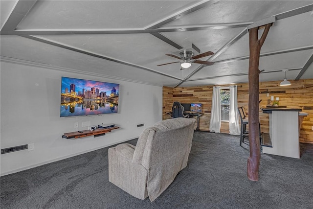 carpeted living area featuring lofted ceiling, a ceiling fan, and wooden walls