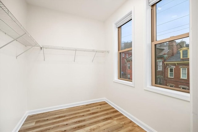 walk in closet featuring wood finished floors