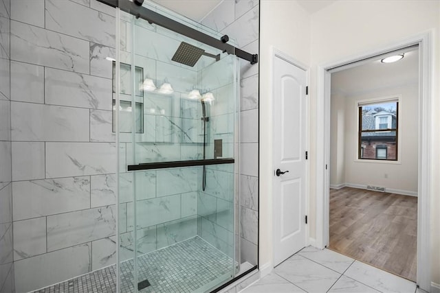 bathroom featuring a stall shower, marble finish floor, visible vents, and baseboards