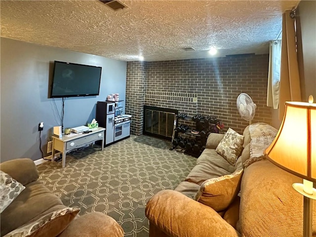 carpeted living area with a large fireplace, baseboards, visible vents, and a textured ceiling