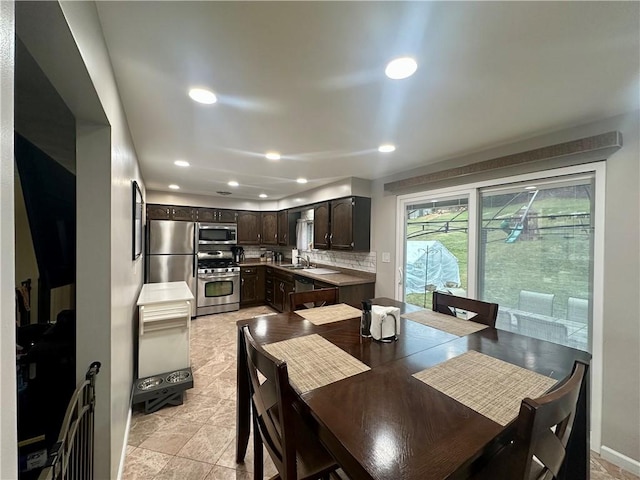 dining area featuring baseboards and recessed lighting