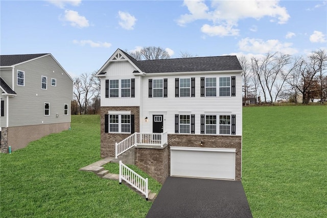 view of front facade with driveway, an attached garage, a front yard, and brick siding