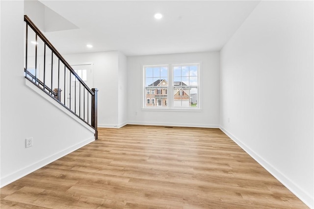 interior space with stairs, recessed lighting, light wood-type flooring, and baseboards