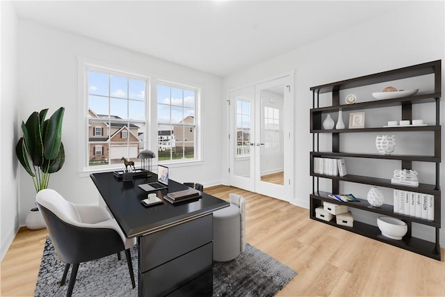 office space with french doors, wood finished floors, and baseboards