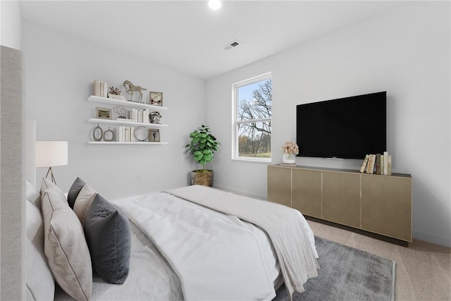 carpeted bedroom featuring visible vents