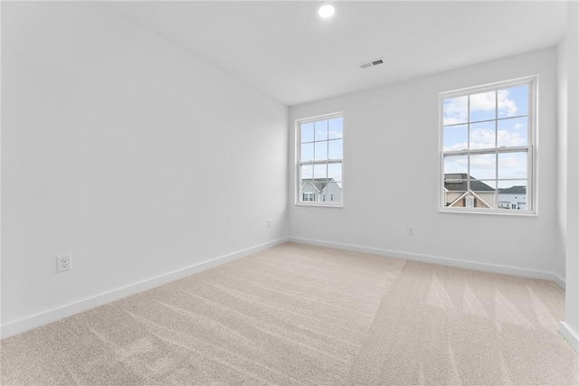 empty room with baseboards, recessed lighting, visible vents, and light colored carpet