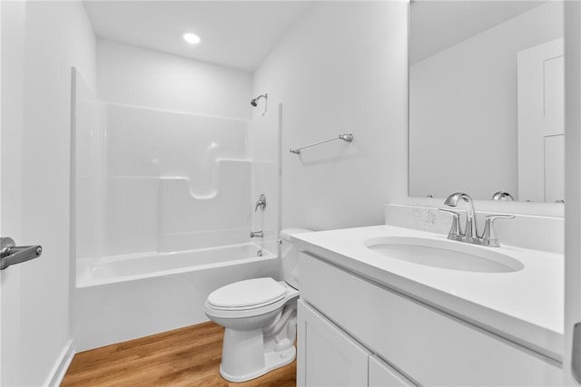 bathroom with bathtub / shower combination, vanity, toilet, and wood finished floors