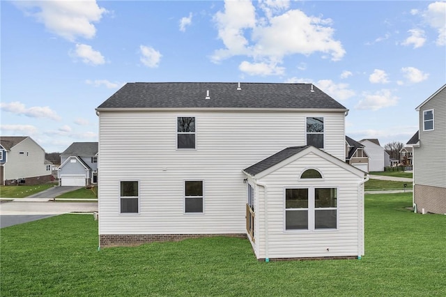 back of property with a residential view and a yard